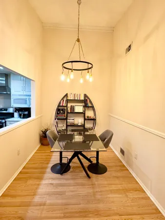 a view of a workspace with furniture and wooden floor