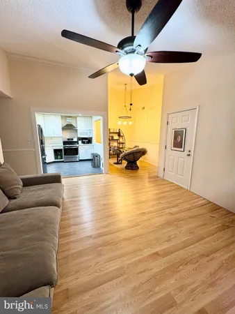 a view of living room with furniture and a chandelier