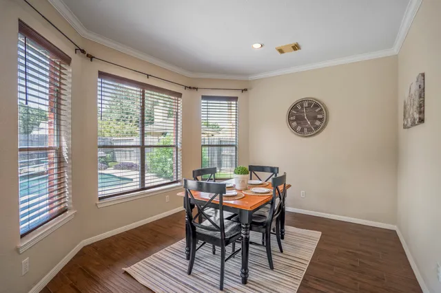 a view of a dining room with furniture window and wooden floor