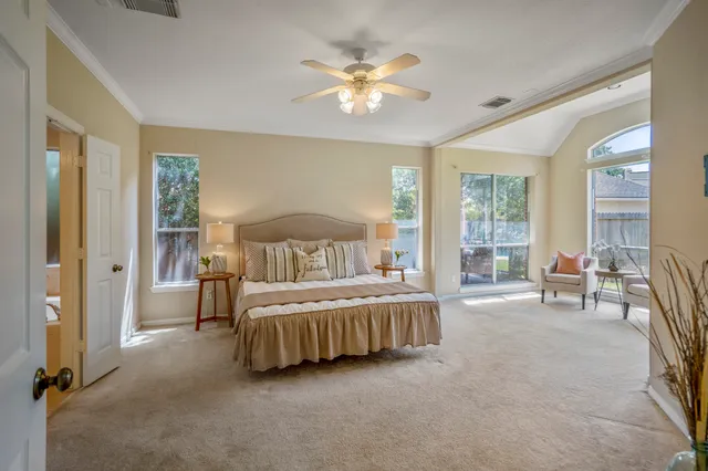 a bedroom with a bed and a large window