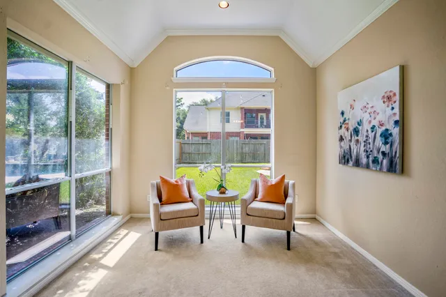 a living room with furniture and a floor to ceiling window