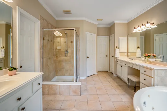 a bathroom with a double vanity sink toilet and shower