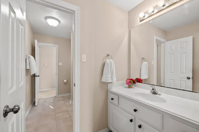 a bathroom with a sink vanity and a mirror