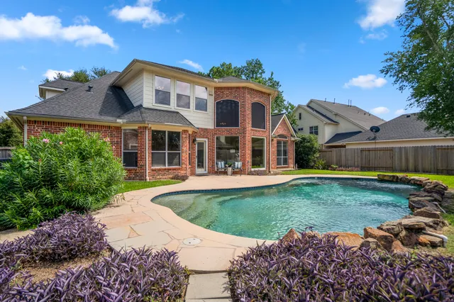 a view of a house with backyard and sitting area