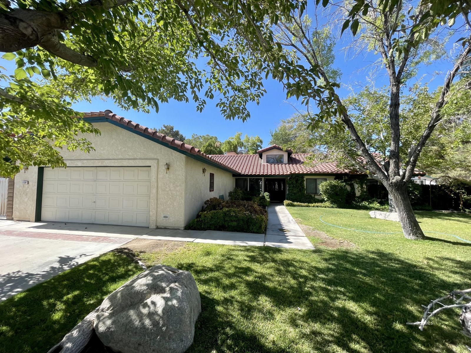 1129 Las Cruces Court Ridgecrest, CA 93555 - Photo 1 of 13 a front view of a house with garden
