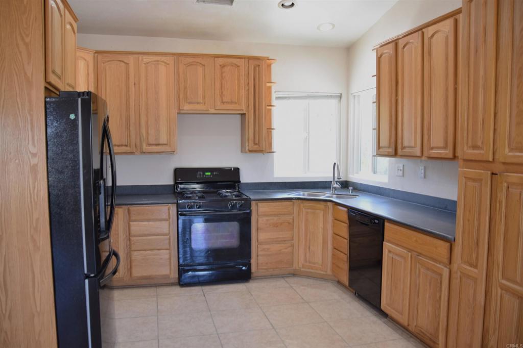 2527 Flying U Road Borrego Springs, CA 92004 - Photo 4 of 12 a kitchen with stainless steel appliances granite countertop a refrigerator and a sink