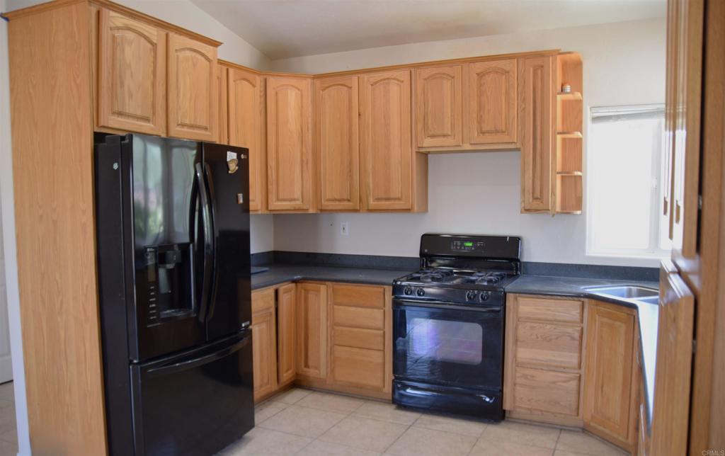2527 Flying U Road Borrego Springs, CA 92004 - Photo 5 of 12 a kitchen with a refrigerator stove and cabinets
