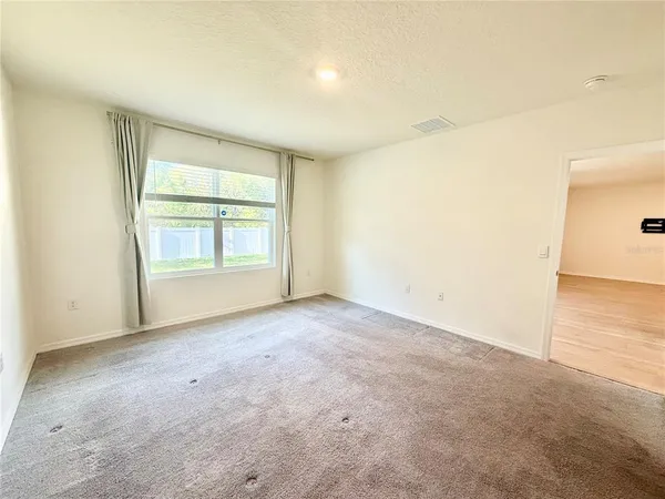 an empty room with windows and closet