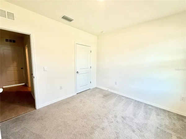 an empty room with wooden floor