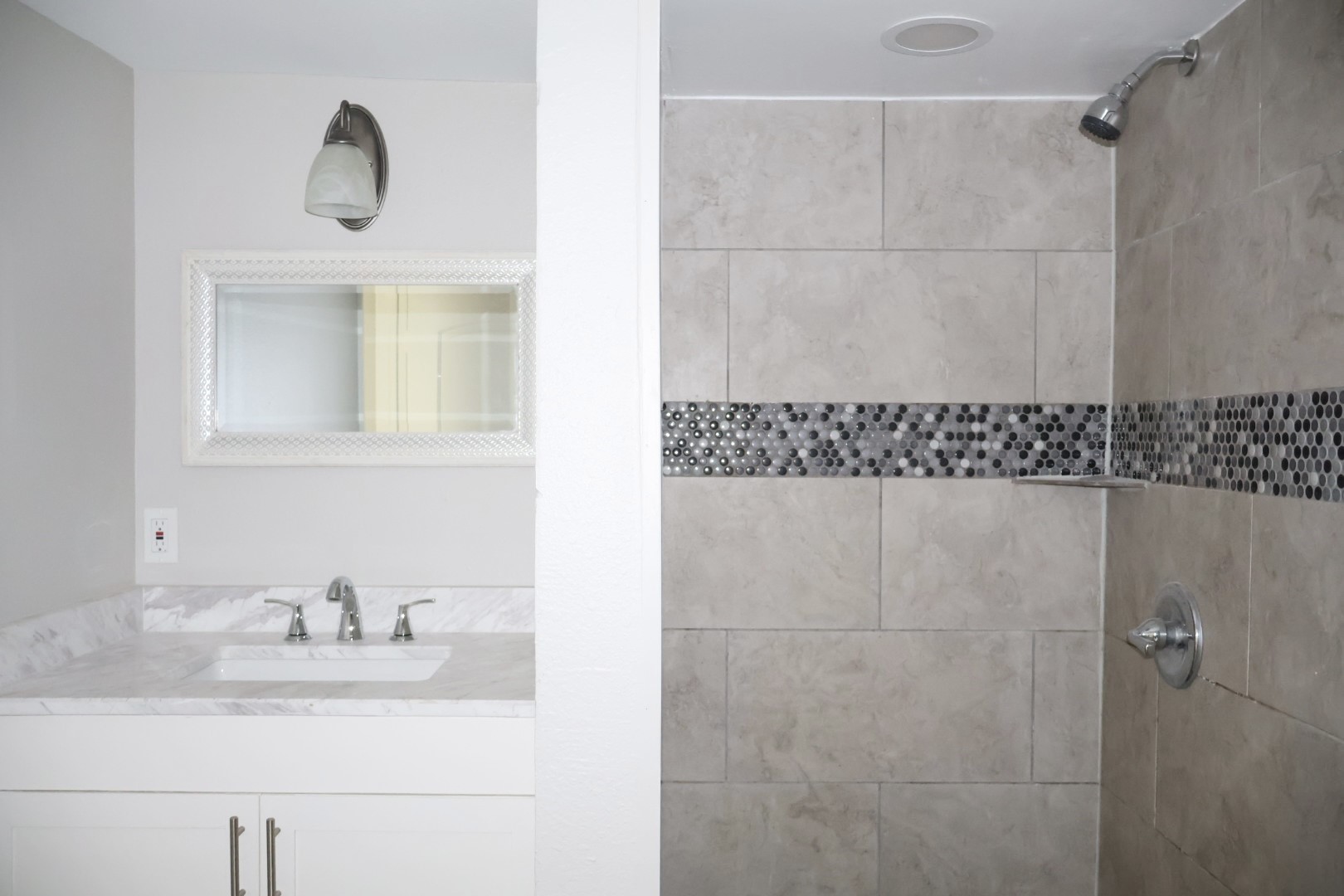 7515 Bayway Drive, Unit 5 Baytown, TX 77520 - Photo 9 of 11 a bathroom with a sink a mirror and a shower