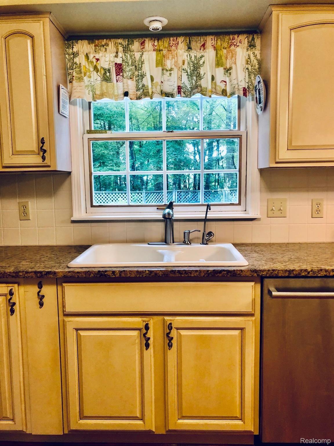 5975 Ludwig Road Oxford, MI 48371 - Photo 22 of 73 Kitchen sink w/ view of patio gardens