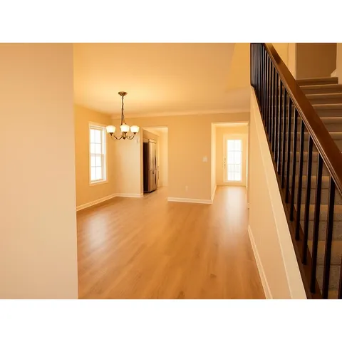 an empty room with a window and a ceiling fan