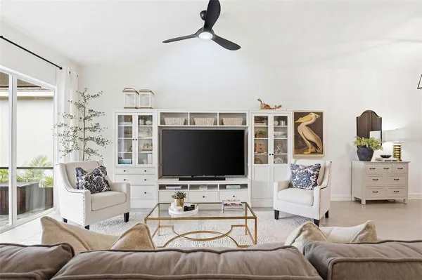 a living room with furniture a window and a chandelier
