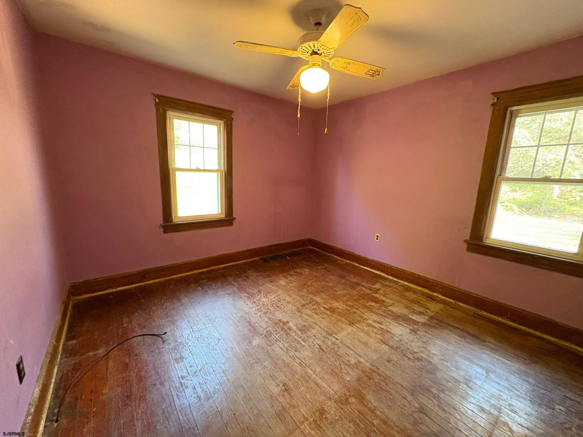 1031 Tuckahoe Road Milmay, NJ 08340 - Photo 11 of 22 an empty room with window and wooden floor