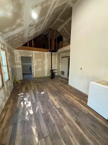 a view of an empty room and wooden floor