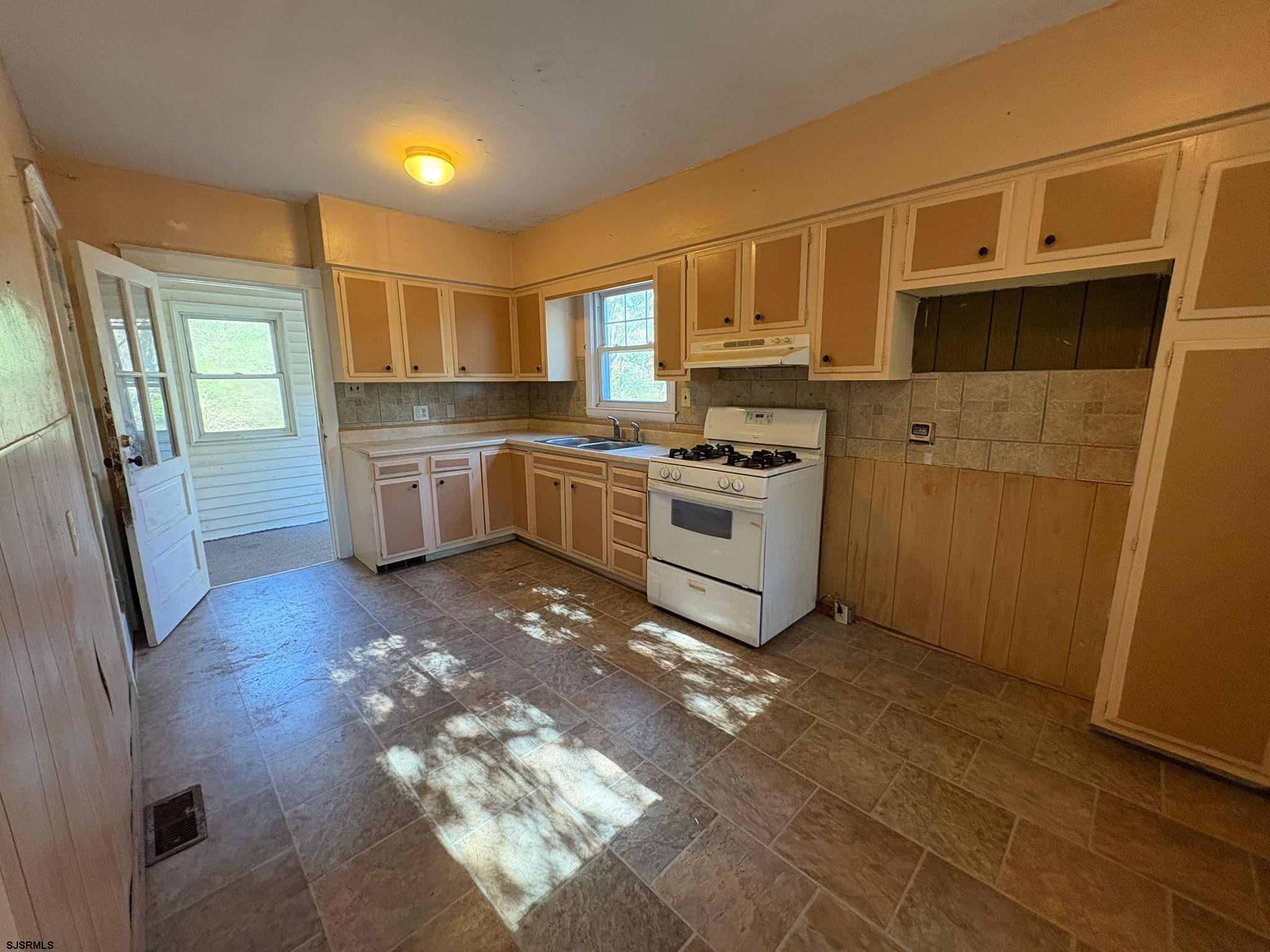 1031 Tuckahoe Road Milmay, NJ 08340 - Photo 14 of 22 a kitchen with stainless steel appliances granite countertop a refrigerator a stove and a sink