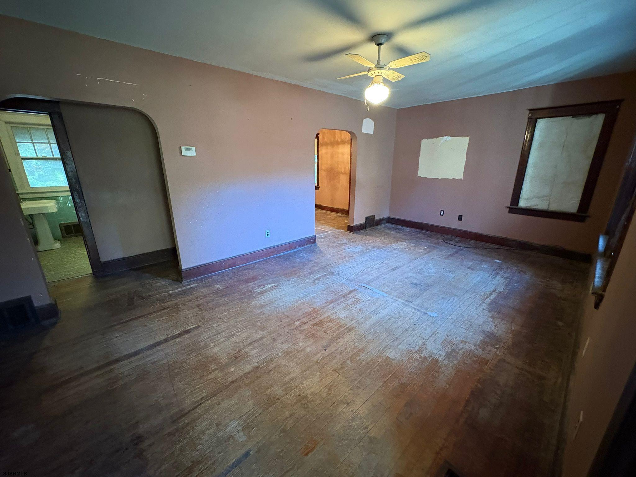1031 Tuckahoe Road Milmay, NJ 08340 - Photo 10 of 22 an empty room with windows and fan