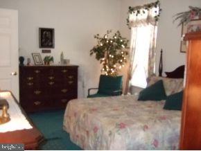 47 Quail Road Barnegat, NJ 08005 - Photo 8 of 12 a bedroom with a bed and a mirror