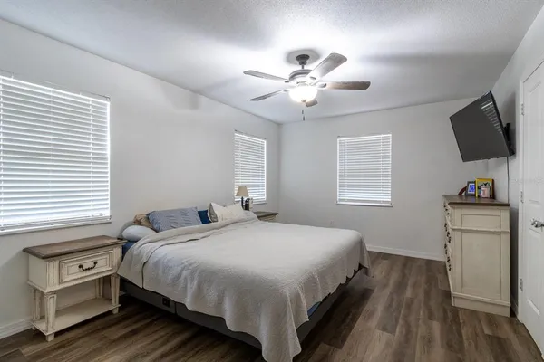 a bedroom with a bed and a tv on the dresser