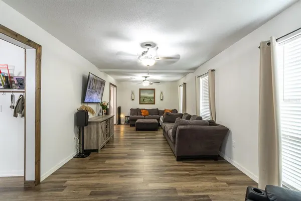 a living room with furniture window and wooden floor