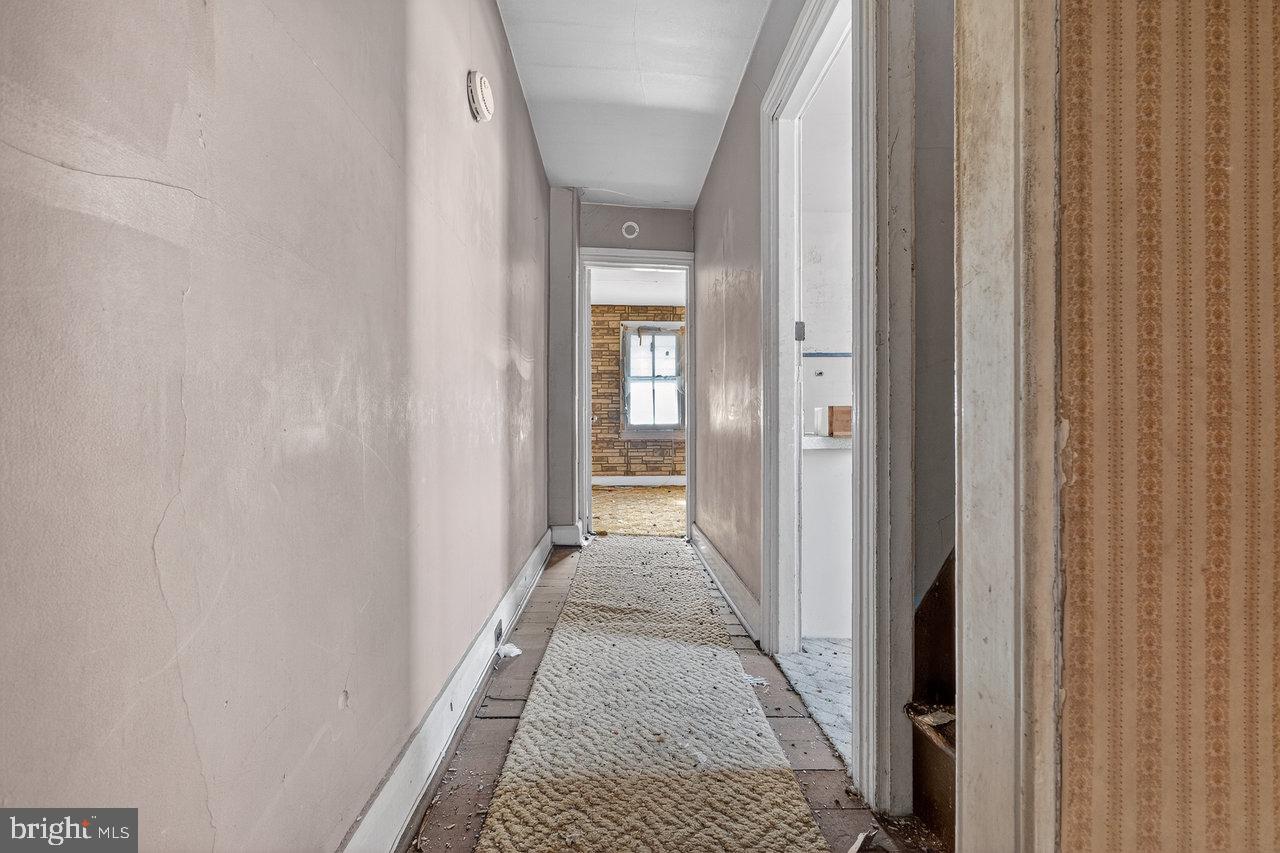 12 Church Street Salem, NJ 08079 - Photo 13 of 15 a view of a hallway with wooden floor and a bathroom