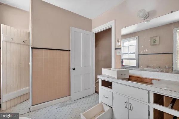 a white toilet sitting next to a bathroom sink