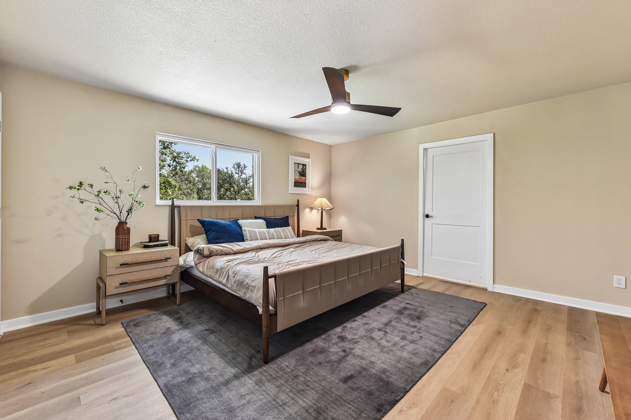 7523 Glenhill Road Austin, TX 78752 - Photo 22 of 38 Hardwood floors and a bright window elevate this welcoming bedroom retreat.