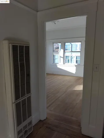a room with walk in closet and wooden floor