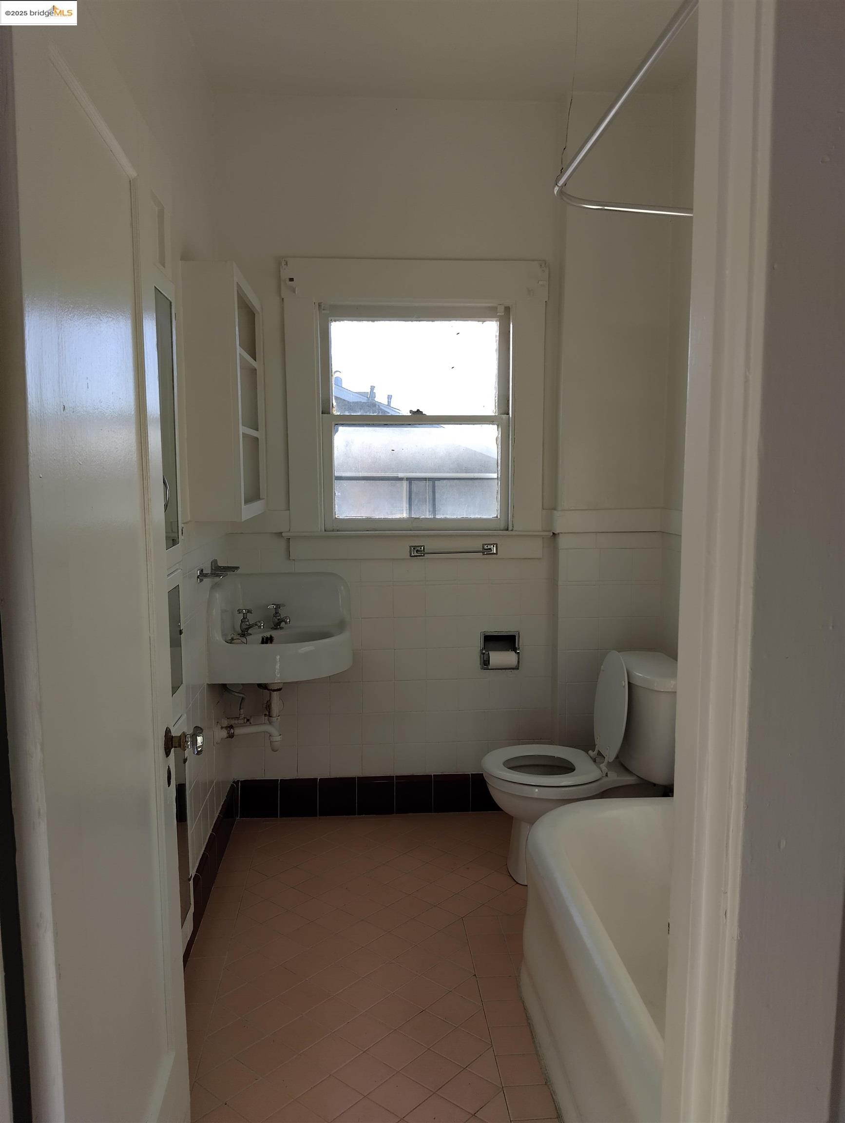 847 East 18th Street Oakland, CA 94606 - Photo 25 of 60 a bathroom with a sink and a toilet