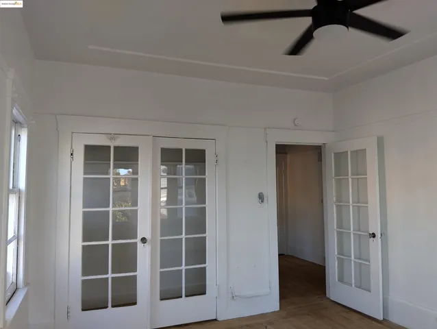 a view of room with stairs and chandelier fan