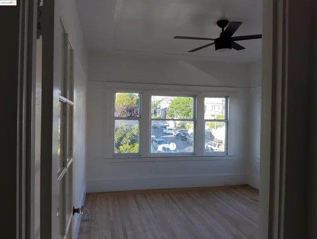 a view of kitchen with wooden floor and electronic appliances