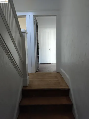a view of wooden floor and windows in a room