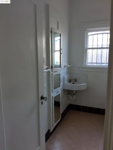 a view of a closet with wooden floor