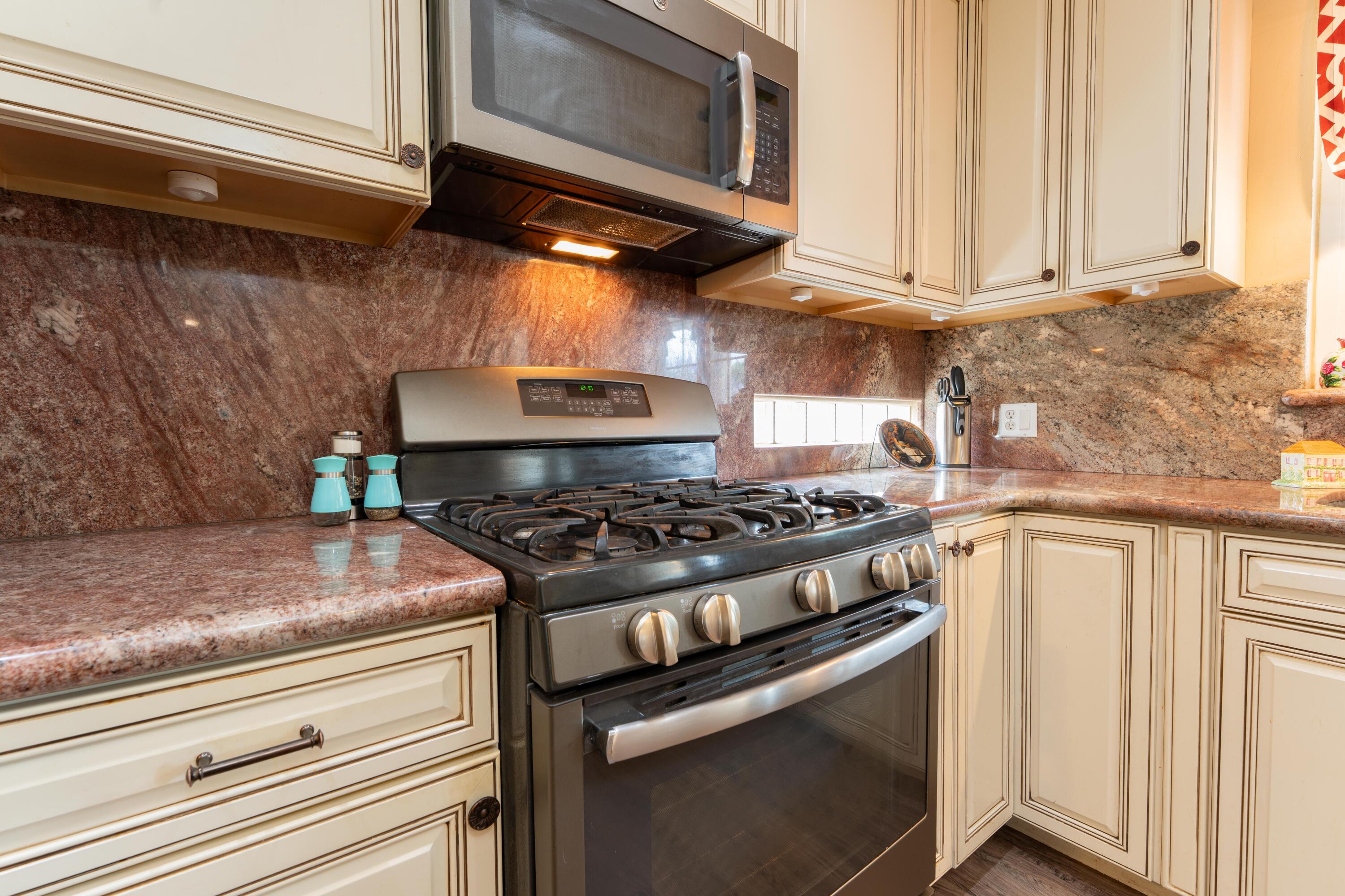 570 North Birch Avenue Reedley, CA 93654 - Photo 17 of 52 a kitchen with a stove and a microwave