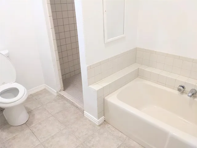 a bathroom with a bathtub and toilet