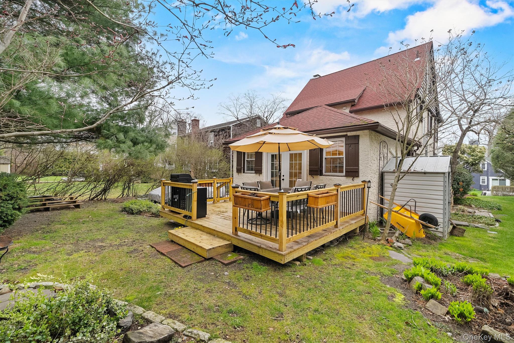 112 Ralph Avenue White Plains, NY 10606 - Photo 28 of 30 Back of house with an outbuilding, a yard, stucco siding, a shingled roof, and a deck