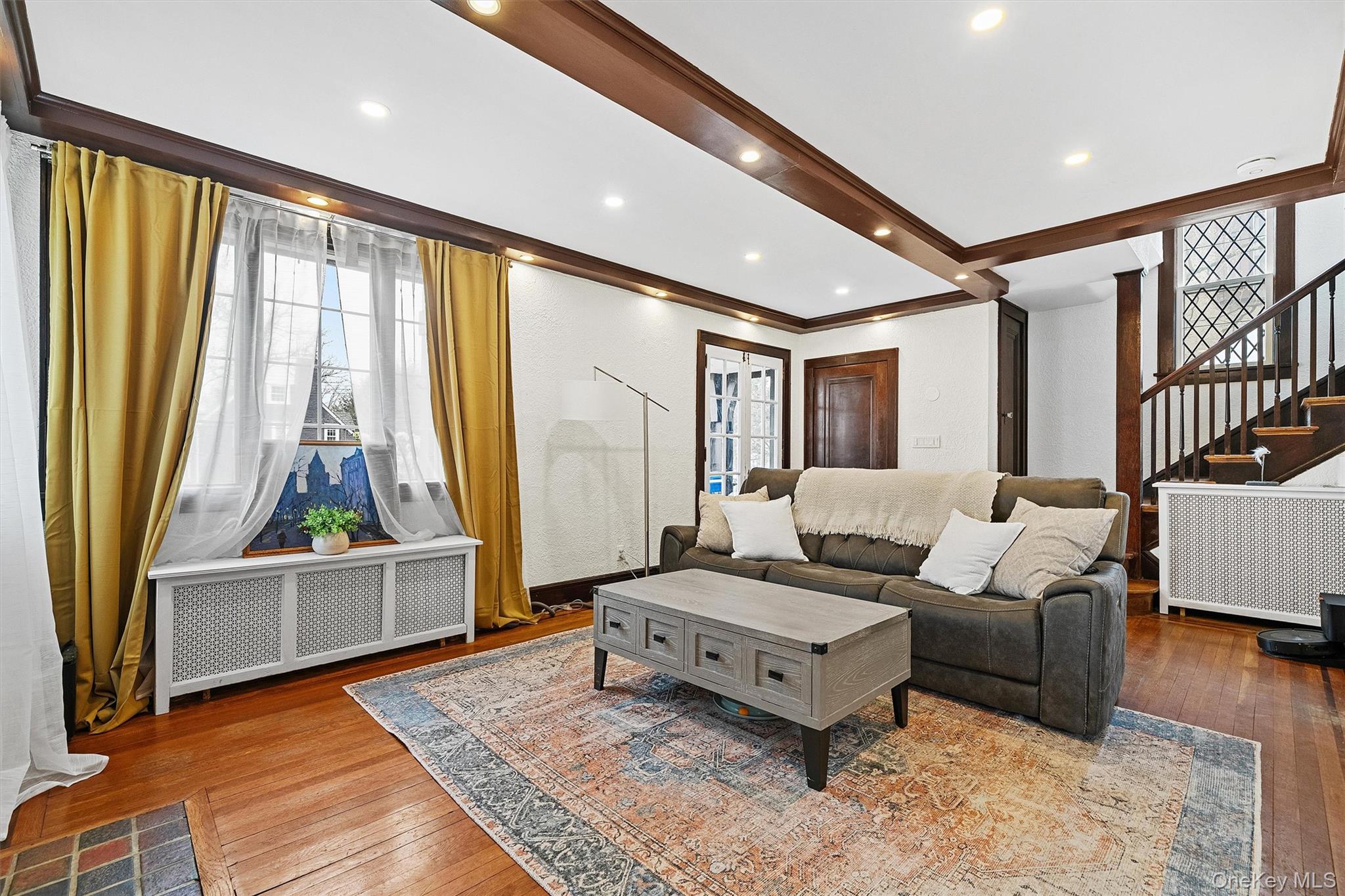 112 Ralph Avenue White Plains, NY 10606 - Photo 6 of 30 Living room featuring recessed lighting, crown molding, stairs, radiator, and wood-type flooring