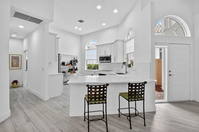 a kitchen with cabinets stainless steel appliances a sink and a stove