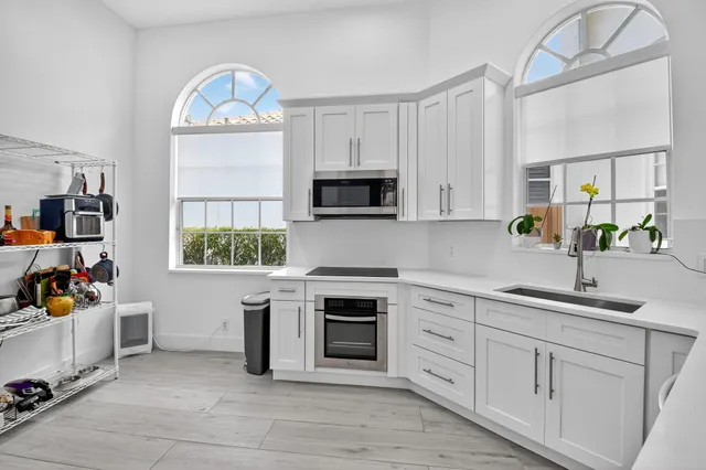 a kitchen with a white cabinets and sink