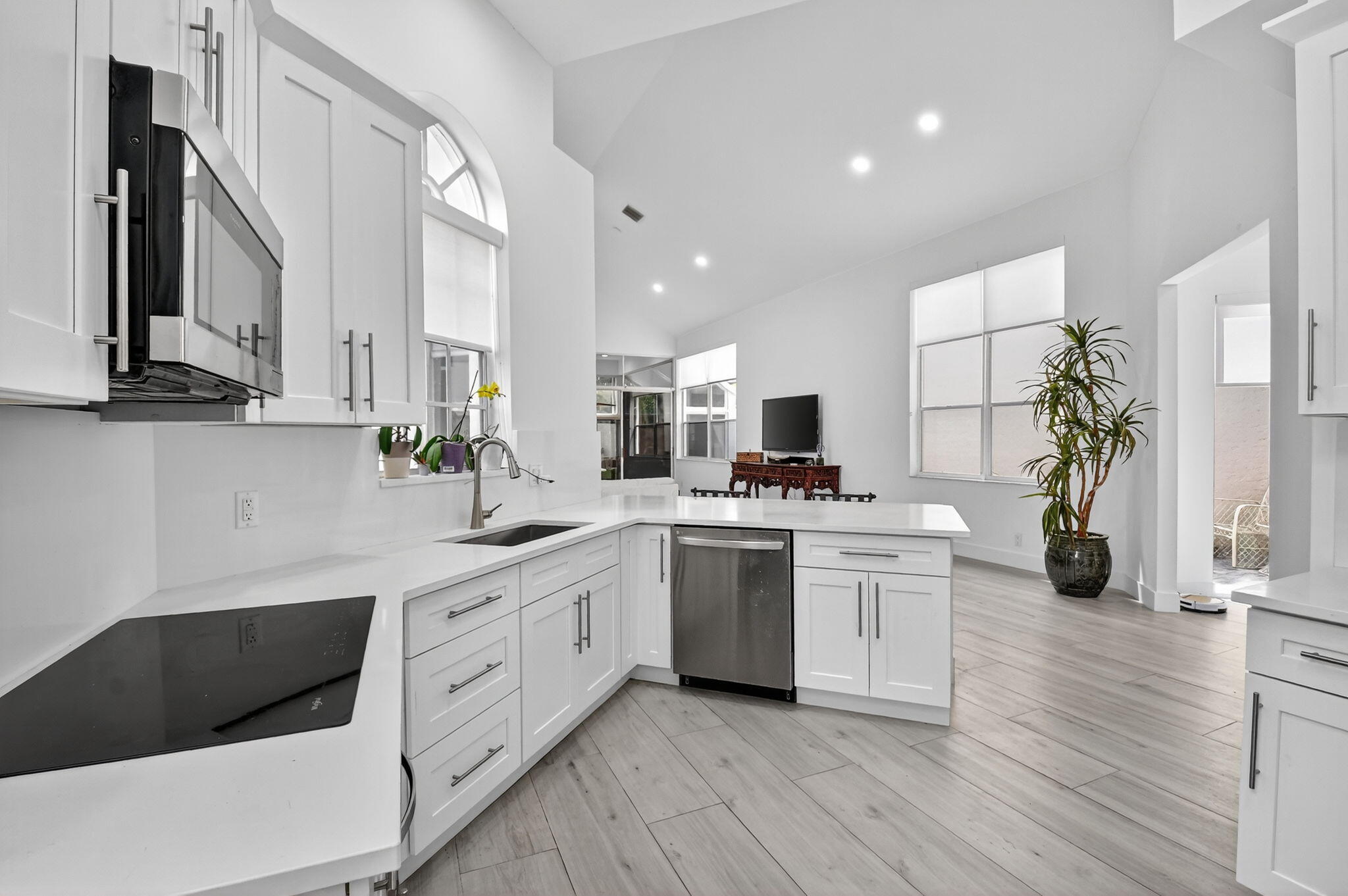 6668 Northwest 25th Terrace Boca Raton, FL 33496 - Photo 14 of 53 a kitchen with a white cabinets and sink