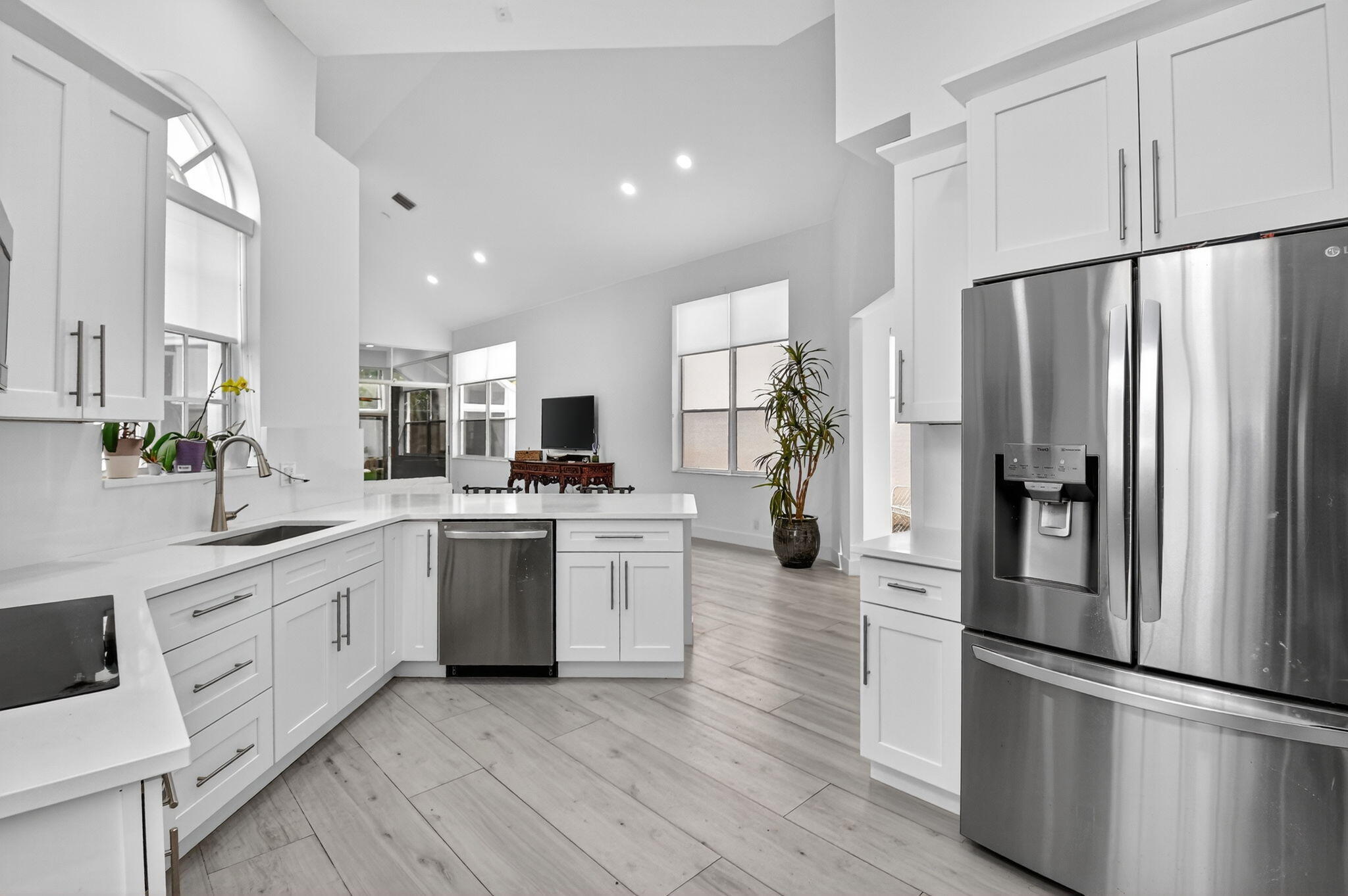 6668 Northwest 25th Terrace Boca Raton, FL 33496 - Photo 15 of 53 a kitchen with white cabinets and stainless steel appliances
