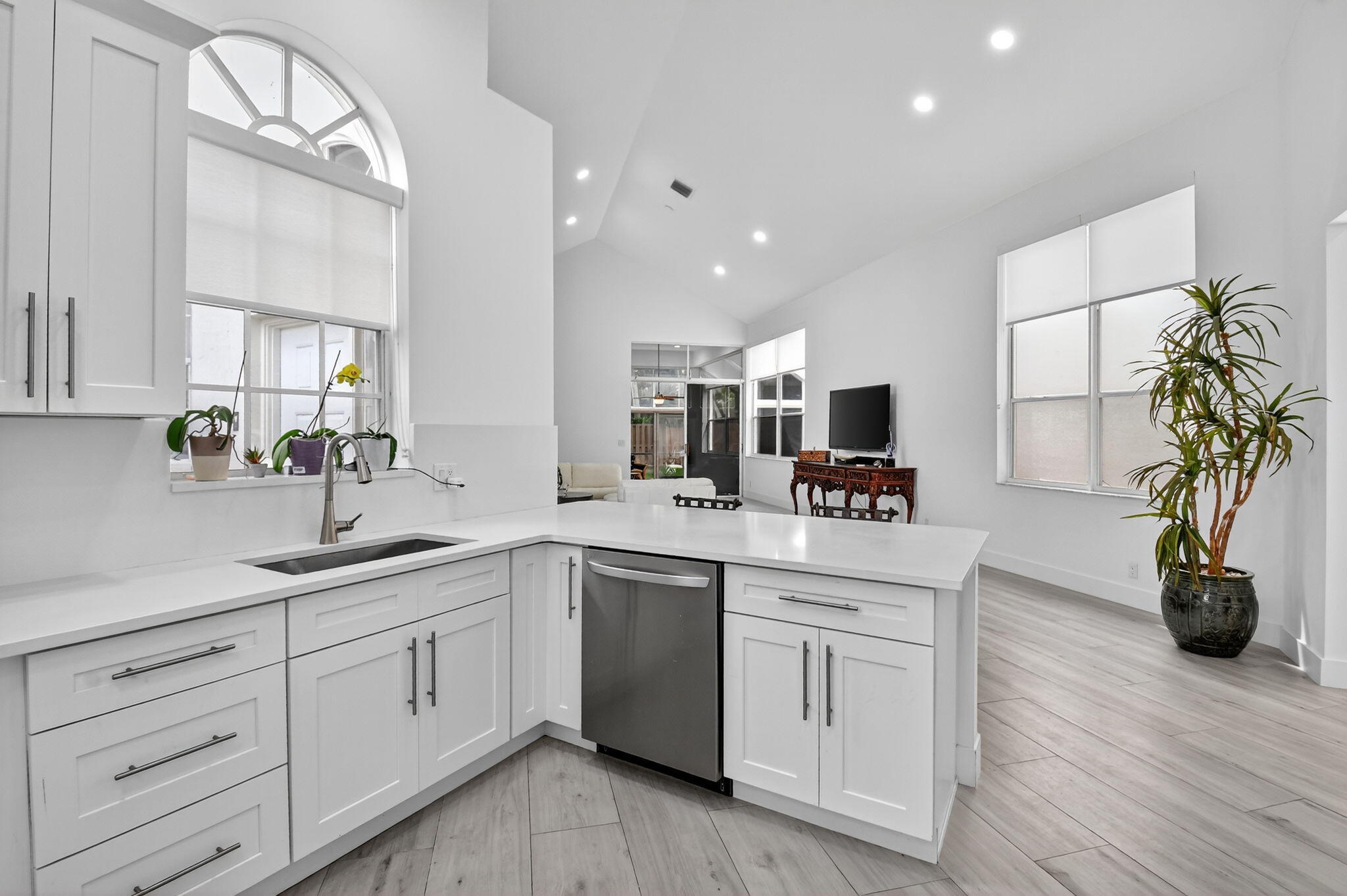 6668 Northwest 25th Terrace Boca Raton, FL 33496 - Photo 16 of 53 a kitchen with white cabinets and sink