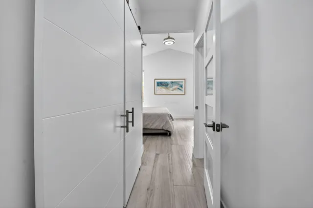 a bedroom with a bed and painting on the wall