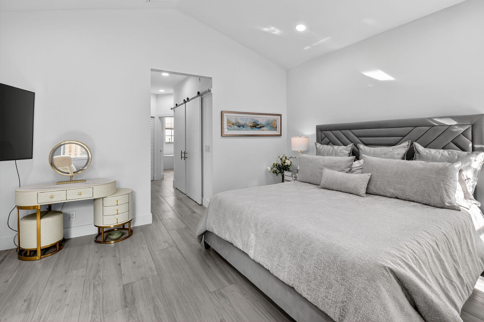 6668 Northwest 25th Terrace Boca Raton, FL 33496 - Photo 26 of 53 a spacious bedroom with a bed and a table