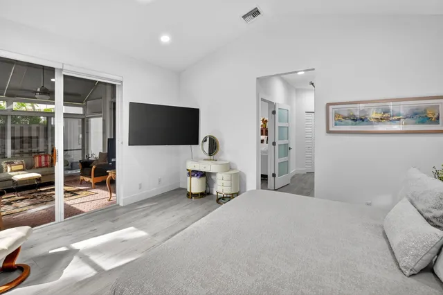 a bedroom with a bed table and a window