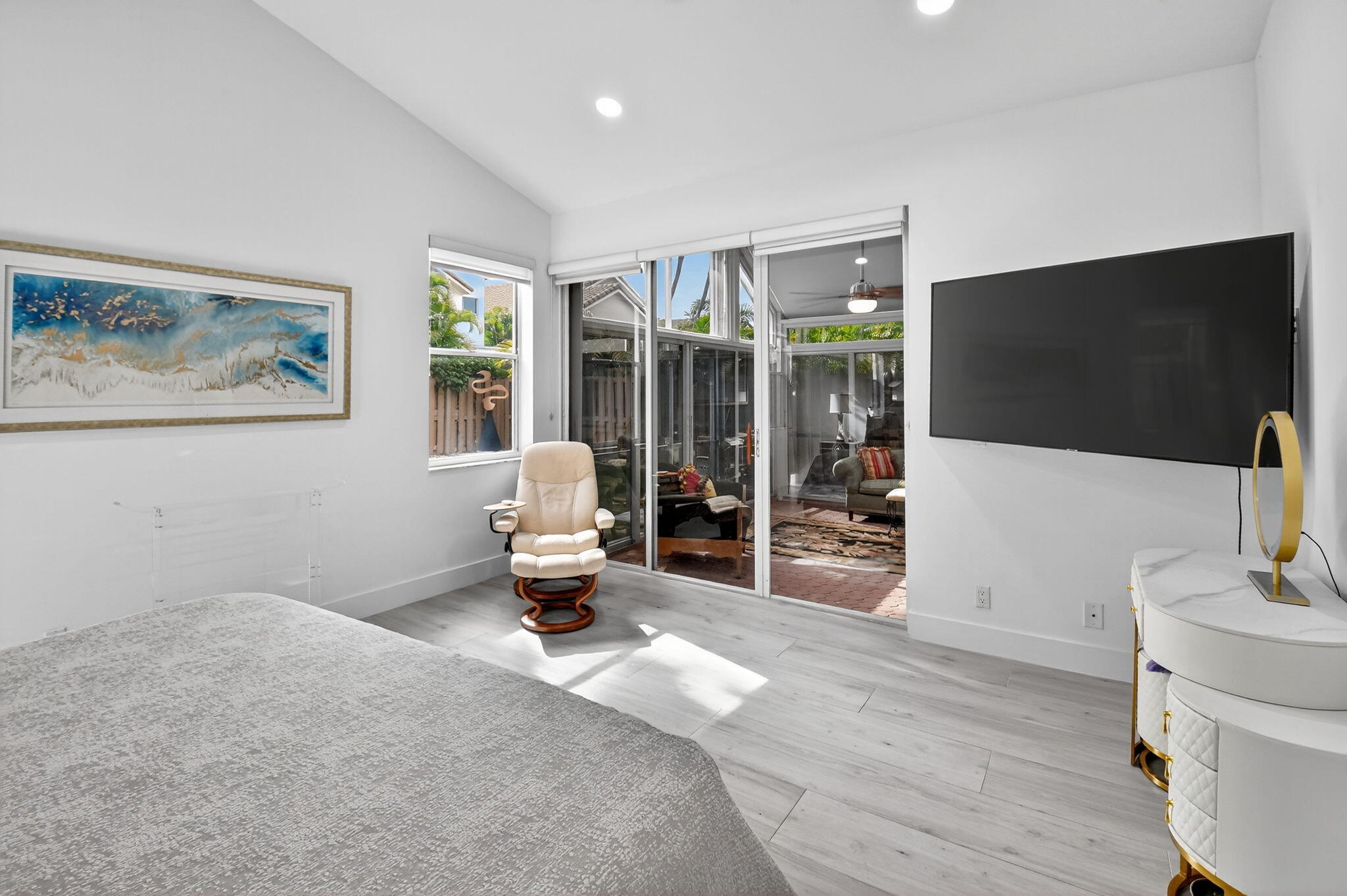 6668 Northwest 25th Terrace Boca Raton, FL 33496 - Photo 29 of 53 a living room with furniture a flat screen tv and a floor to ceiling window