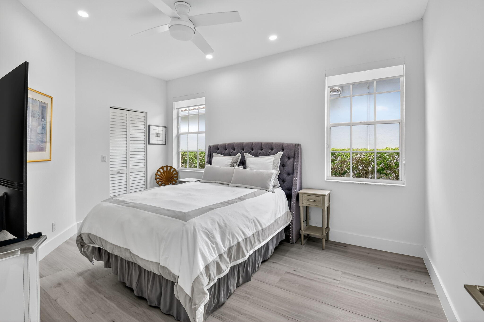 6668 Northwest 25th Terrace Boca Raton, FL 33496 - Photo 30 of 53 a bedroom with a bed table and a window