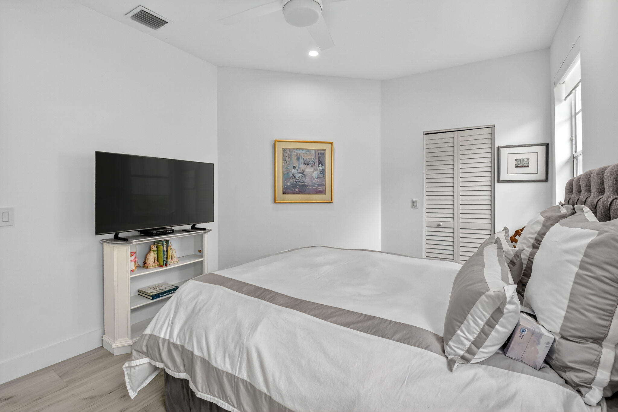 6668 Northwest 25th Terrace Boca Raton, FL 33496 - Photo 31 of 53 a bedroom with a bed and a flat screen tv