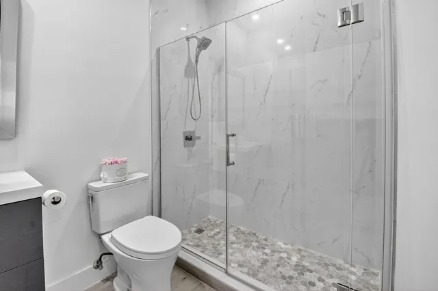 a living room with furniture a flat screen tv and a table