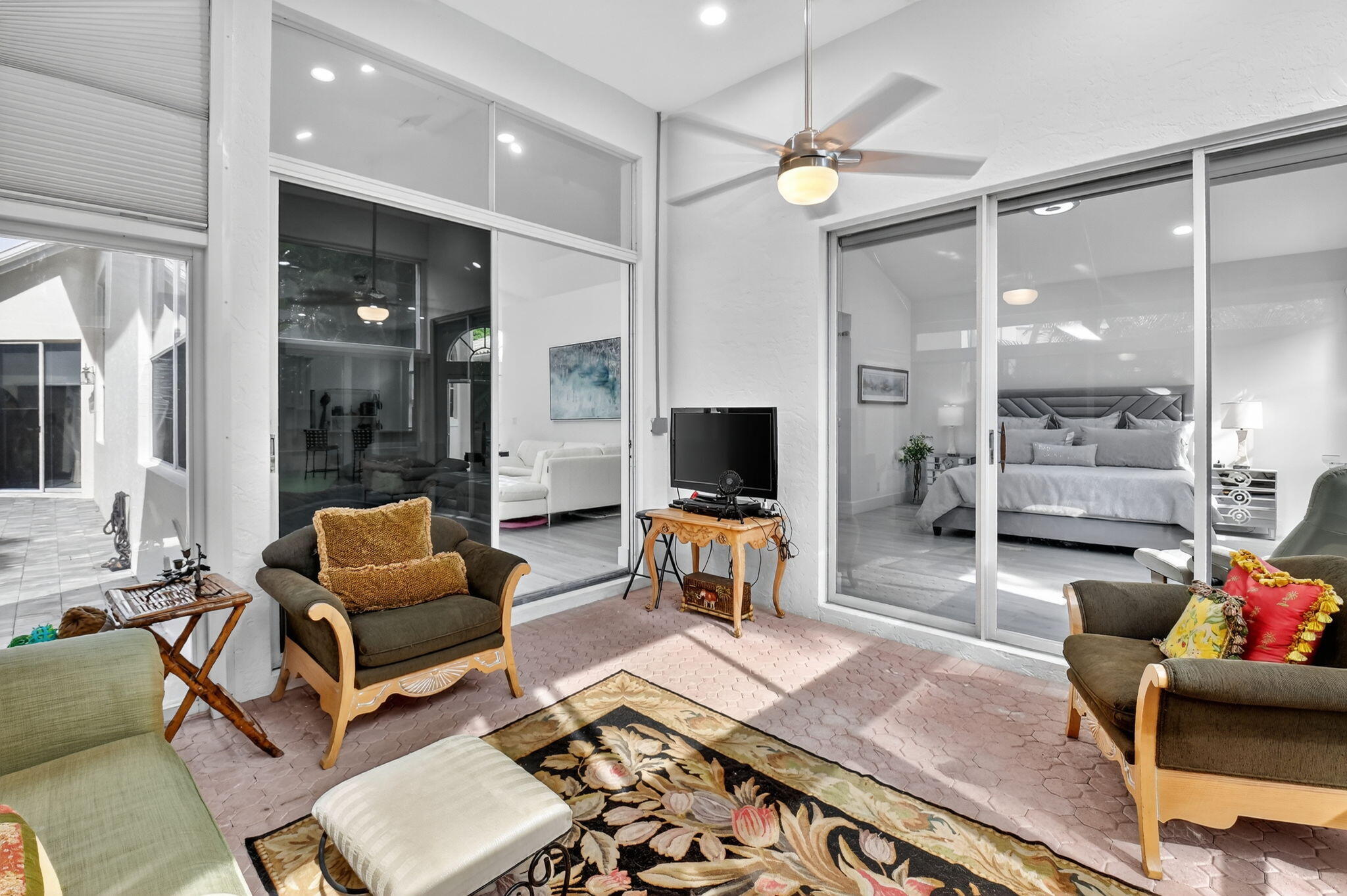 6668 Northwest 25th Terrace Boca Raton, FL 33496 - Photo 35 of 53 a living room with furniture a flat screen tv and a table